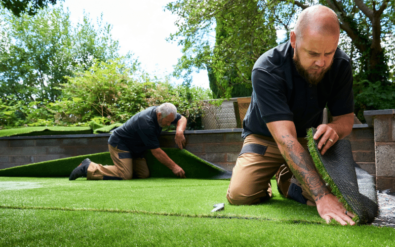 workers-laying-artificial-turf